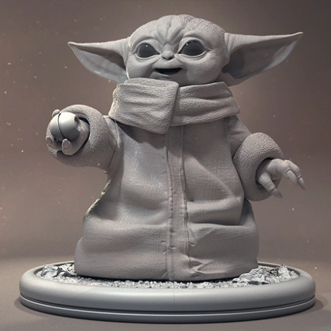 Baby Yoda in a Santa outfit, holding a green ornament, standing on a round base.